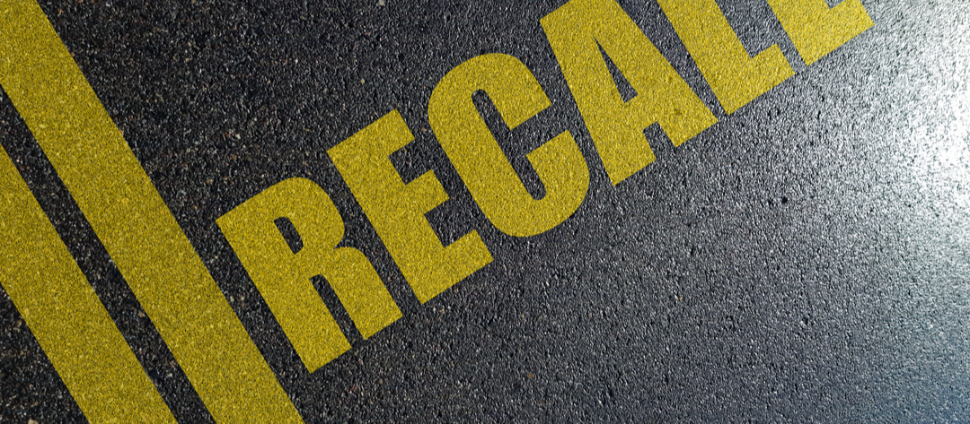 word recall painted on asphalt in yellow