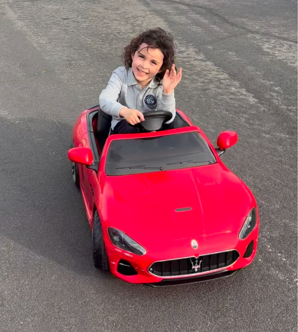 Aria Boyan waves from her new mini car, won in the Kars4Kids 30th anniversary Cars for Kids celebration giveaway