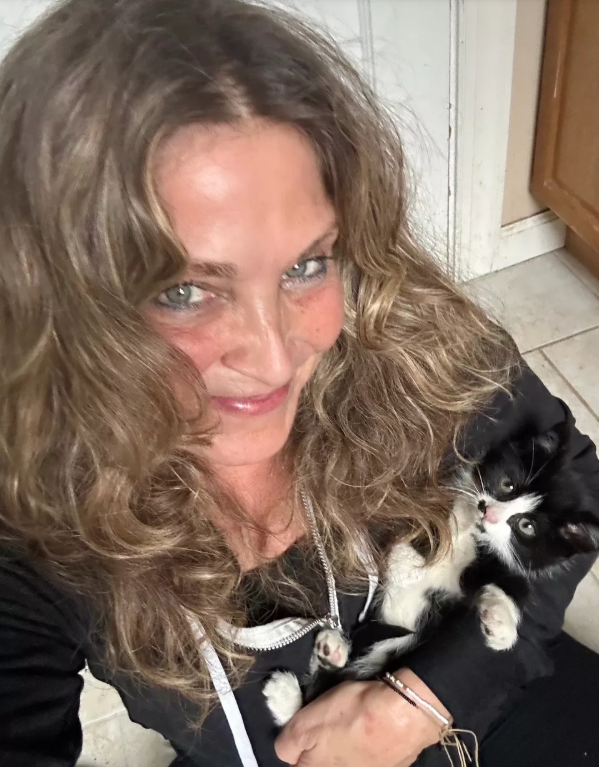 Rescuer Whitney Malin holds kitten Beemer.