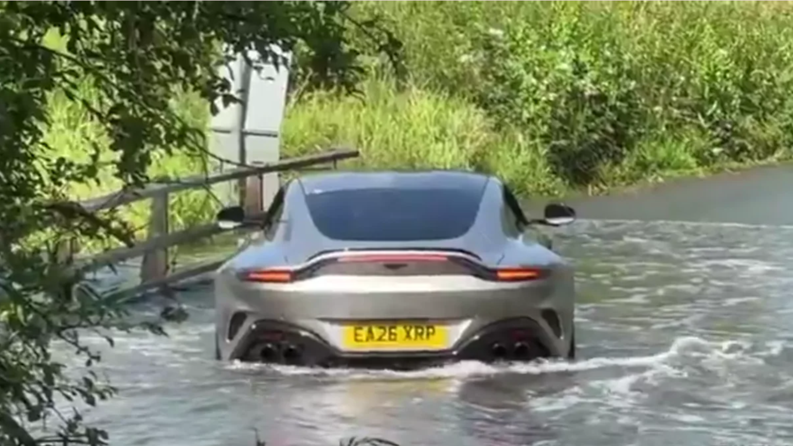 Aston Martin plunges into flooded roadway